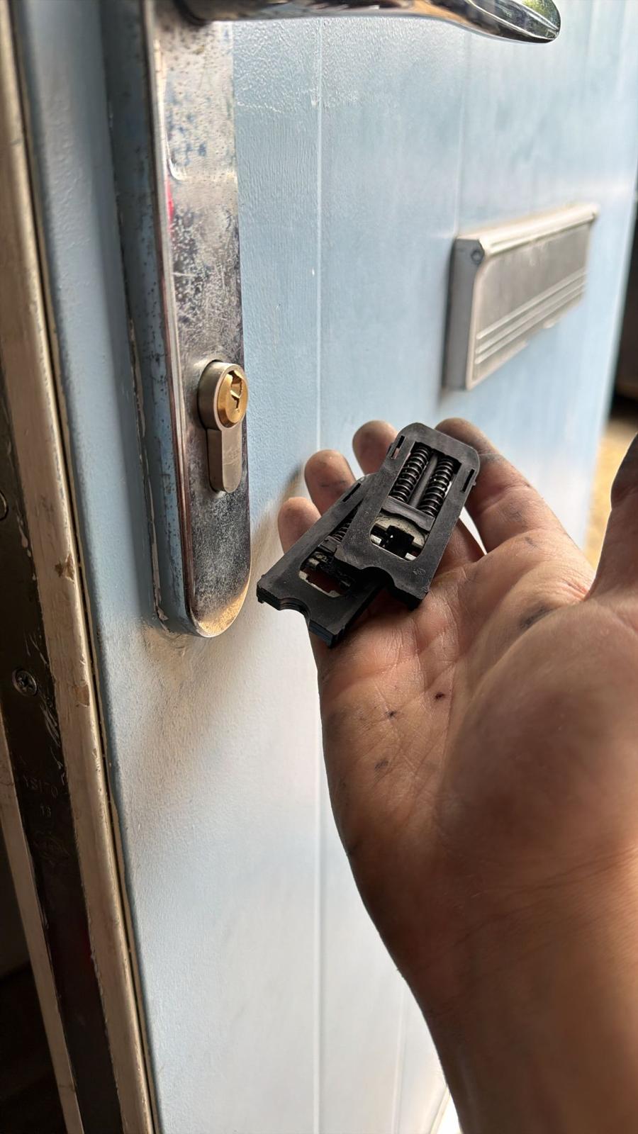 Lock cylinder mechanism removed from a door by hand